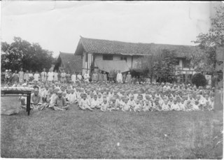Entertaining a group from the famine camp just before they broke up camp & went back (C.A. Bridgman) to their own chores. Credit: Bridgman Family.